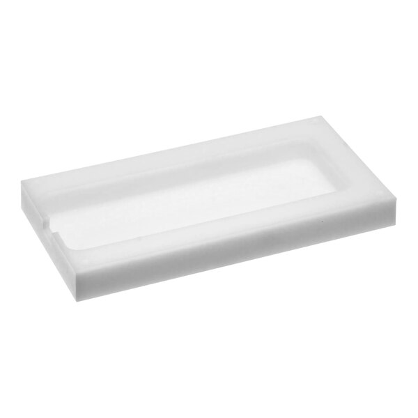 A white rectangular plastic cover with a hole in it.