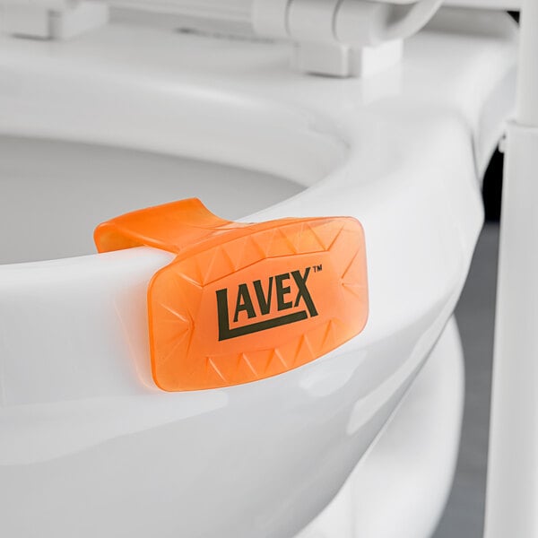 A white toilet seat with a Lavex Citrus Scent Gel Toilet Bowl Clip on it.