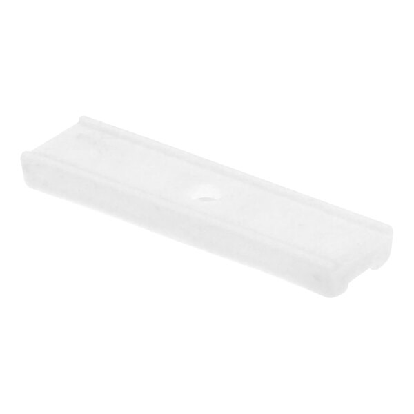 A white rectangular plastic piece with a hole in it.
