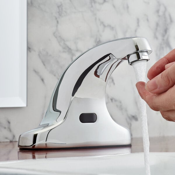 A person washing their hands with a Waterloo hands-free sensor faucet.