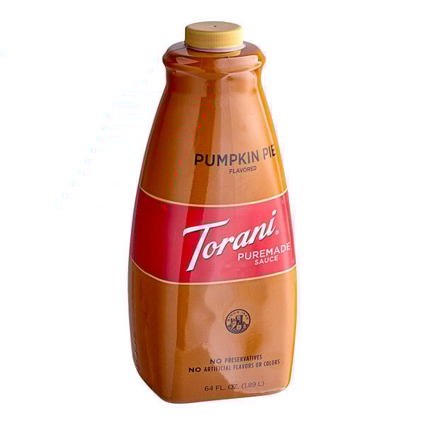 A close up of a Torani Pumpkin Pie flavoring sauce bottle with a red label.