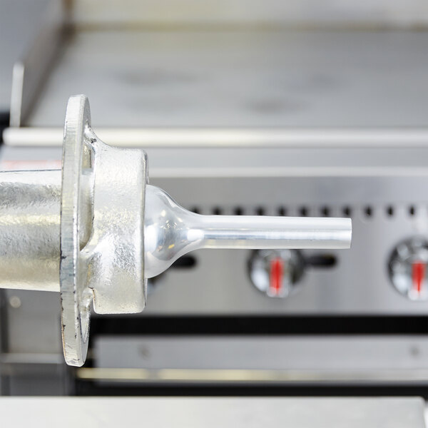A close up of the Hobart #32 Large Stuffing Horn for meat grinders.