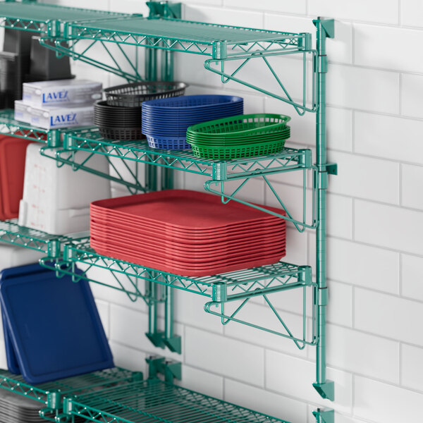 A green Regency wire rack with blue trays on it.