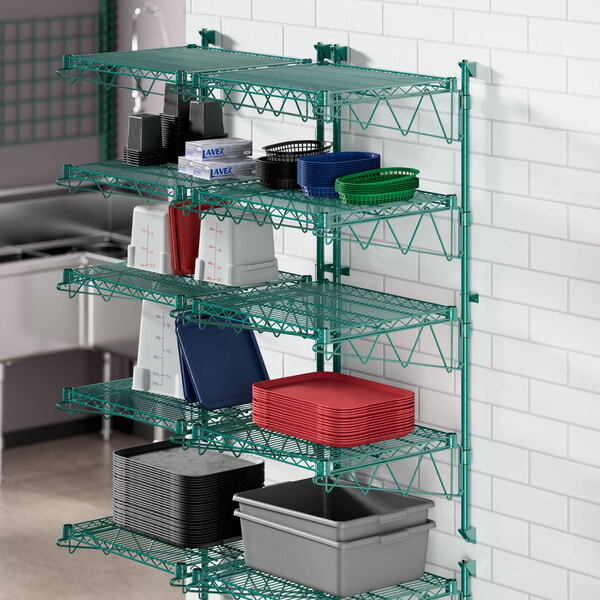 A green wire shelving unit with grey plastic containers on a shelf.