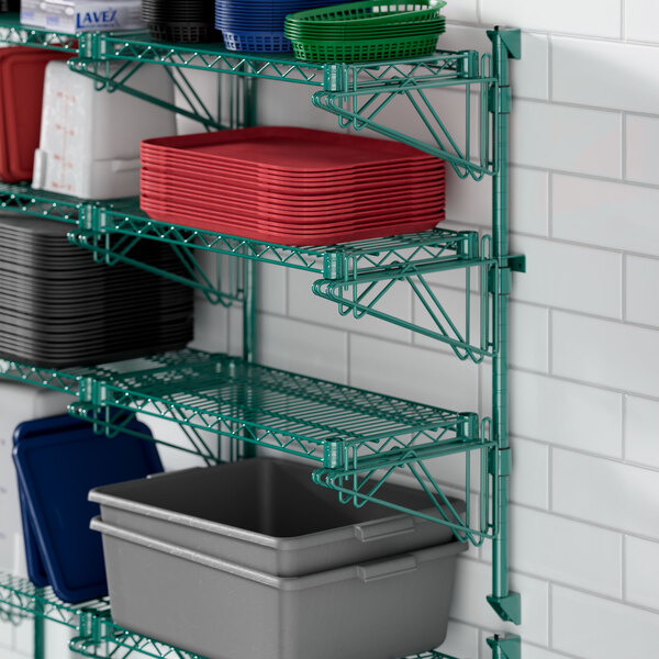A Regency green wire shelf with blue, black, and clear plastic containers.