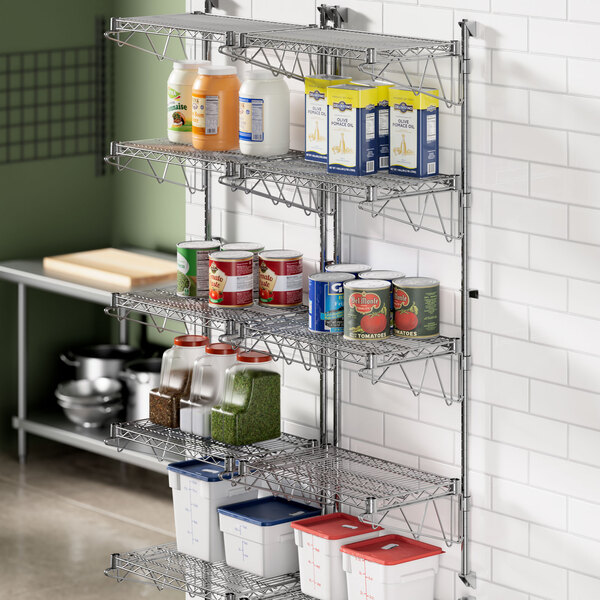 A metal Regency wall-mount shelf unit holding food items.