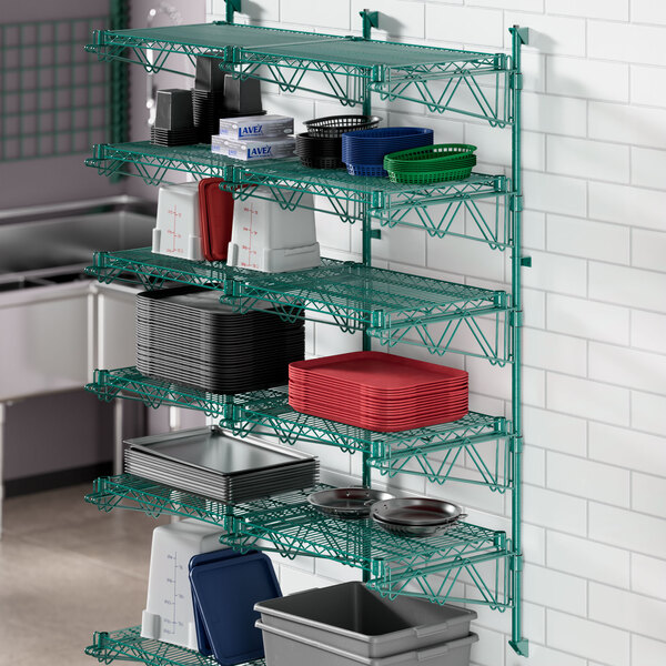 A green Regency wire shelving unit with various containers on it.