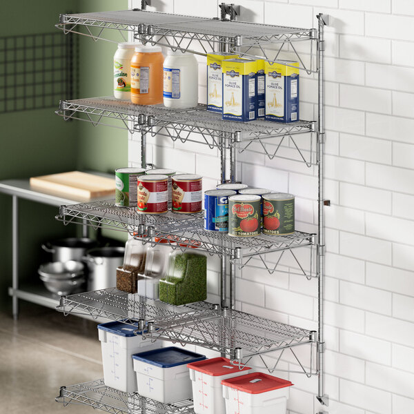 A Regency stainless steel wall-mount shelf post with shelves filled with food.
