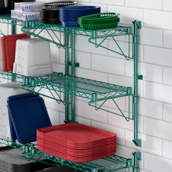 A green Regency wire shelf with white and red trays on it.