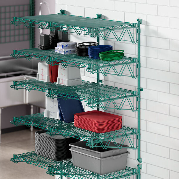 A green Regency wire shelf with grey and colored plastic containers on it.