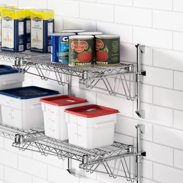 A Regency chrome wall-mount shelf with containers and cans on it.