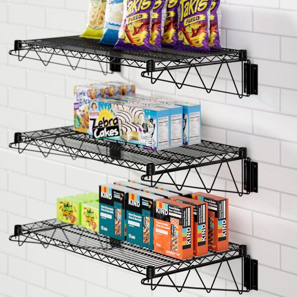A Regency black epoxy wire shelf holding snacks and snacks.