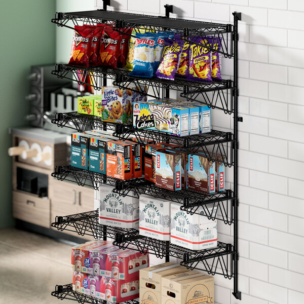 A Regency black wire shelf with food and snacks on it.