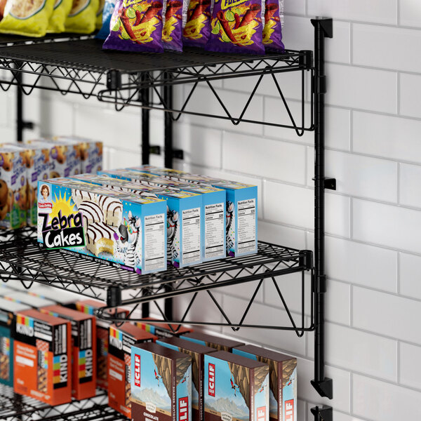 A Regency wire wall-mount shelf with snacks and drinks on it.