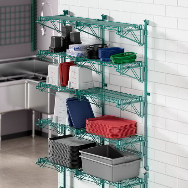 A Regency green wire shelf with containers on it.