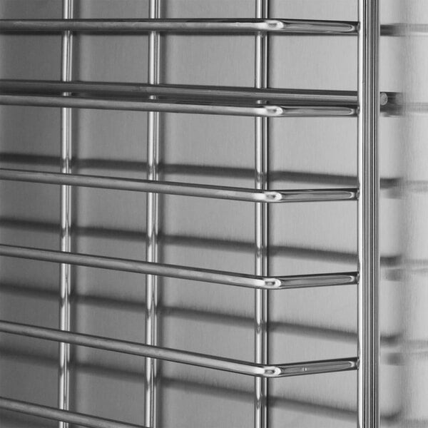 A stainless steel heated holding and proofing cabinet with horizontal wire shelves and a clear door.