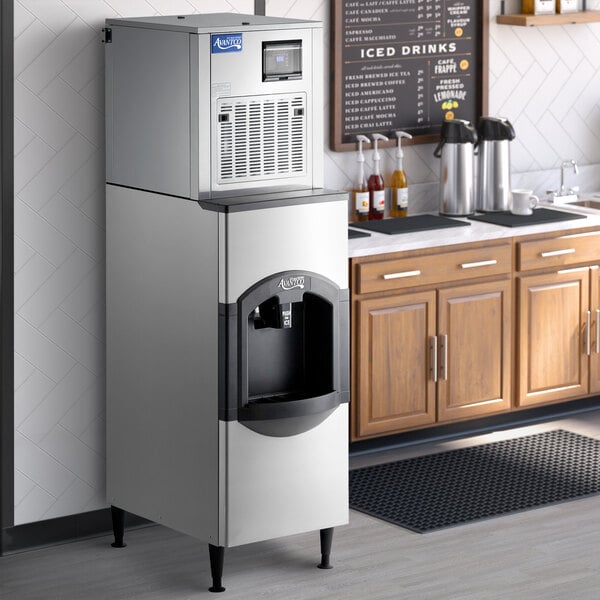 An Avantco air cooled modular nugget ice machine with a dispenser on a counter.