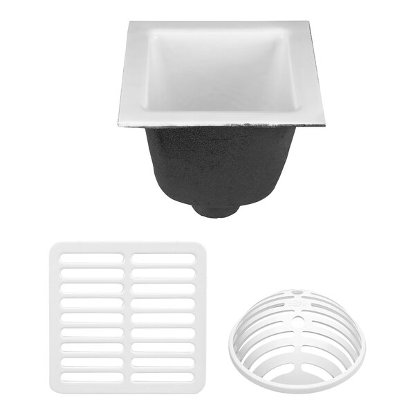 A white Zurn cast iron floor sink with a white plastic drain cover with holes.