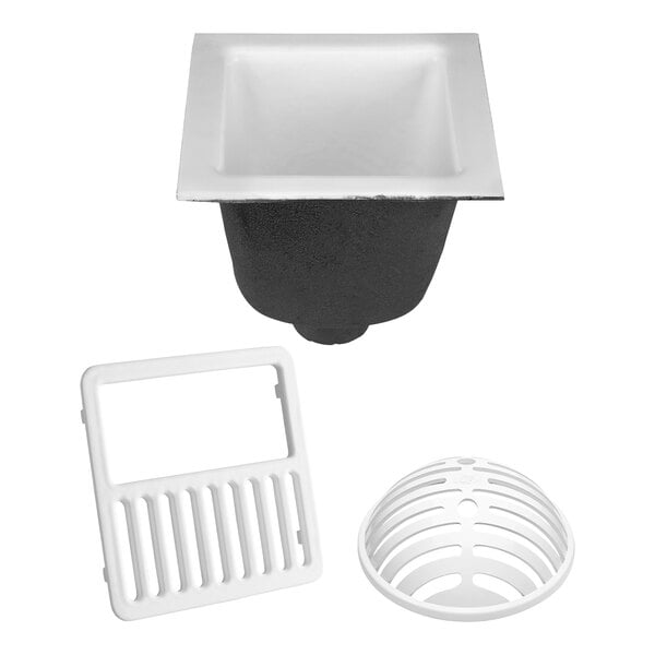A white Zurn floor sink with a white drain cover with holes.