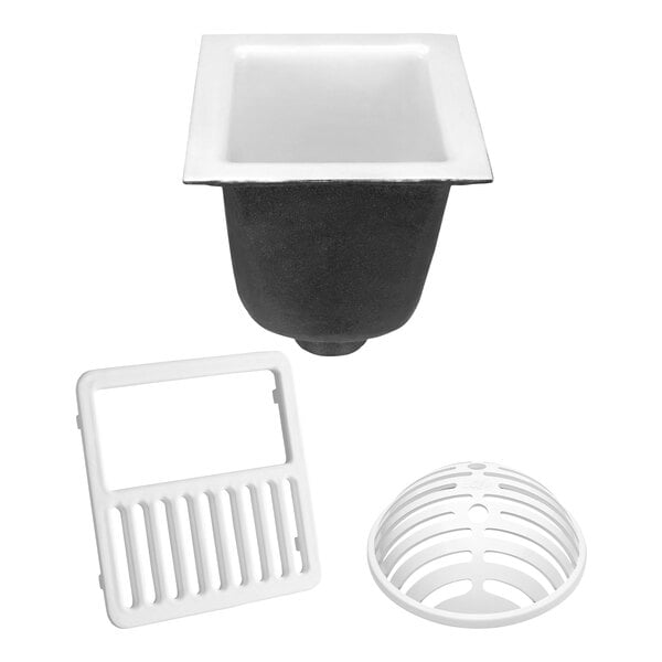 A white Zurn cast iron floor sink with a black square grate over a drain.
