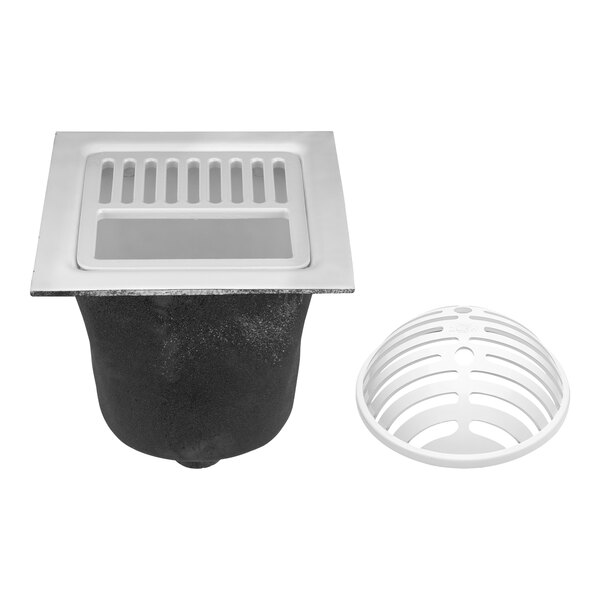 A white rectangular Zurn cast iron floor sink with a black grate over the drain hole.