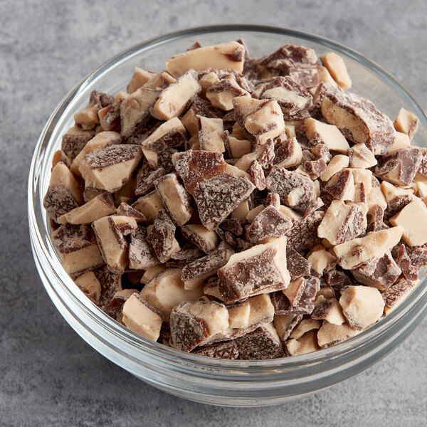 A bowl of HEATH toffee chunks on a table.