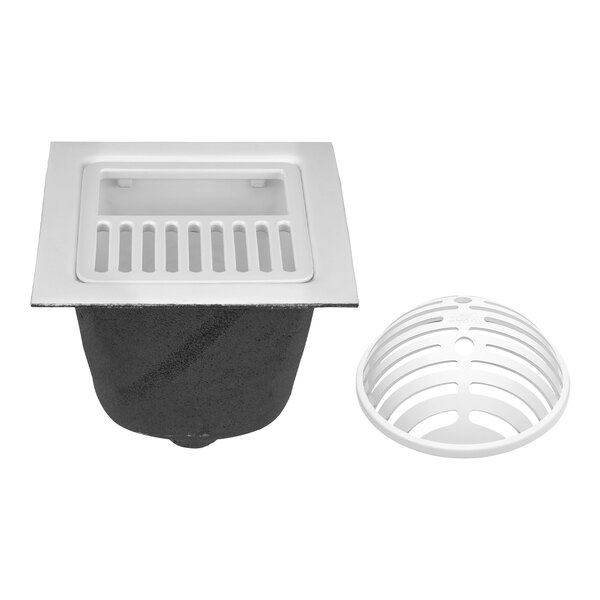 A white cast iron floor sink with a white drain cover.
