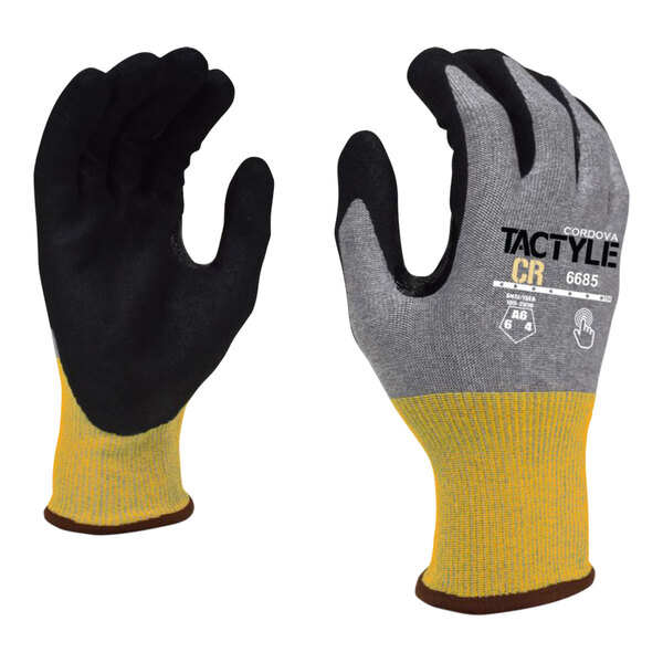 A pair of Cordova Tactyle gloves with a yellow and black Tuf-Cor sandy nitrile palm coating.