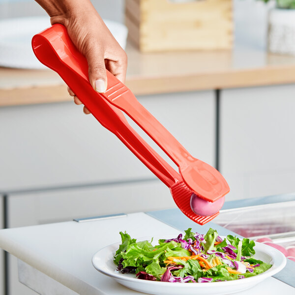 Red Polycarbonate Flat Grip Tongs being used to serve salad