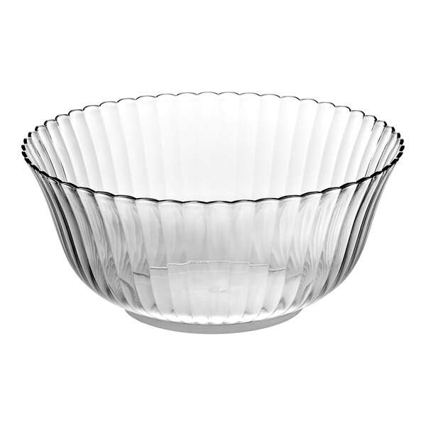 A clear plastic punch bowl with a curved edge.