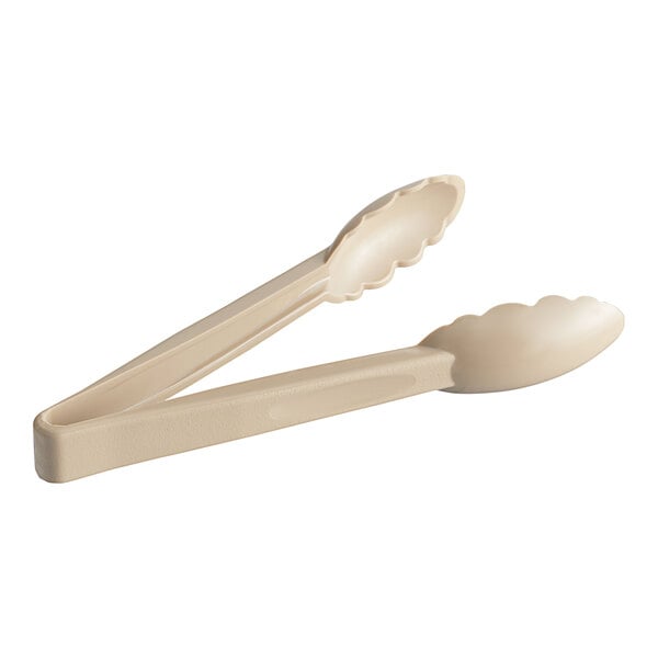 A pair of Choice beige polycarbonate tongs with scalloped grips and white handles.