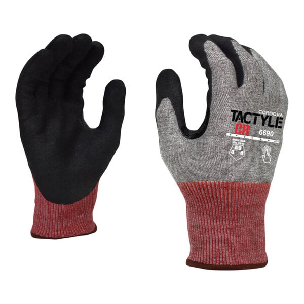 A close-up of a pair of black Cordova Tactyle gloves with red and black fabric on the palm.