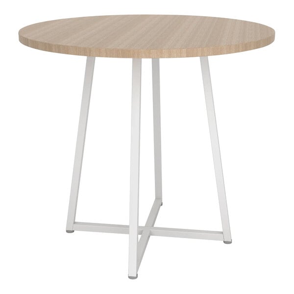 A Econoco round nesting display table with a white metal base and raw oak woodgrain top.