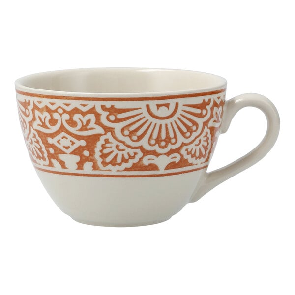 A white cappuccino cup with orange and intricate designs.