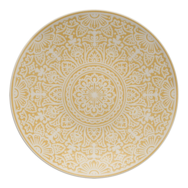 A close up of a yellow and white Havana by Fortessa coupe plate with intricate designs.