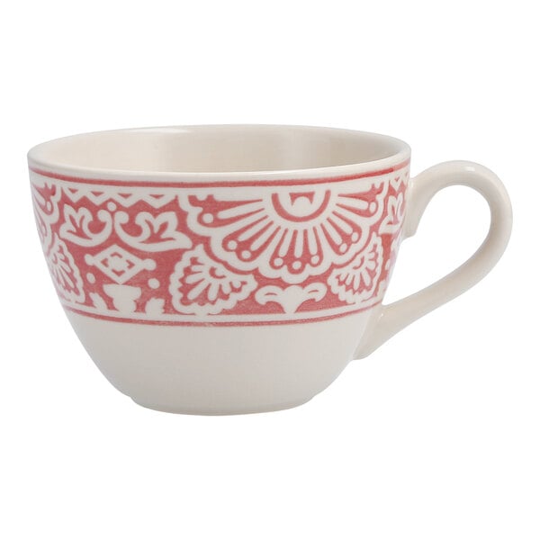 A white cappuccino cup with a pink and red design on it.