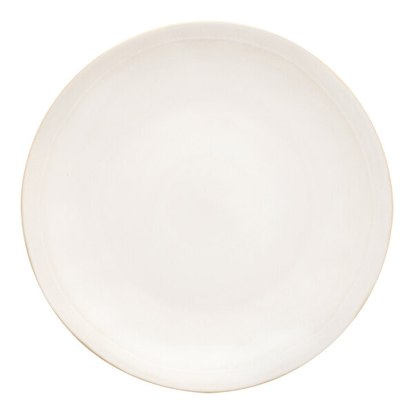 A white stoneware plate with a gold rim.