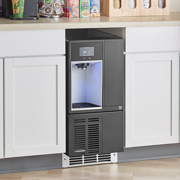 A black and silver Follett Champion 7 Series undercounter ice maker and water dispenser with a blue light.