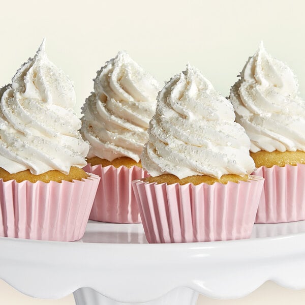 A group of cupcakes with white frosting on top.