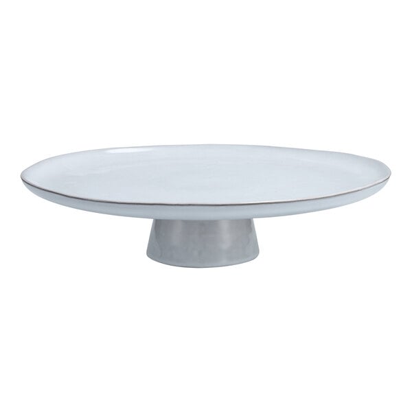 A white stone cake stand with a silver metal base.