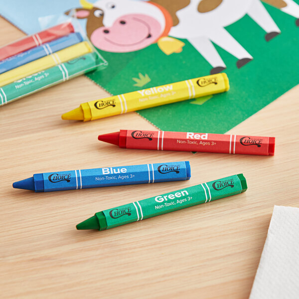 A group of hexagonal green, blue, and red Choice Kids' Restaurant Crayons on a table.