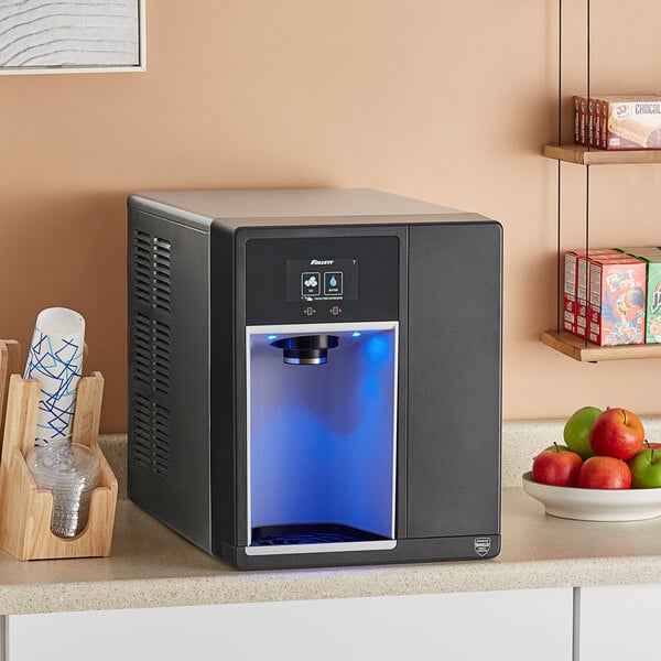 A black rectangular Follett countertop ice maker and dispenser with a blue light.