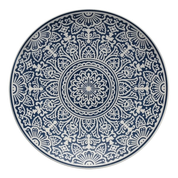 A white Havana by Fortessa coupe plate with a blue circular design on it.