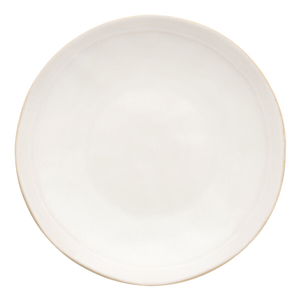 A white stoneware plate with a gold rim.