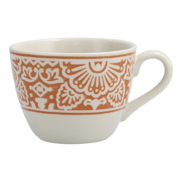 A close up of a white Havana coffee cup with orange and white design.