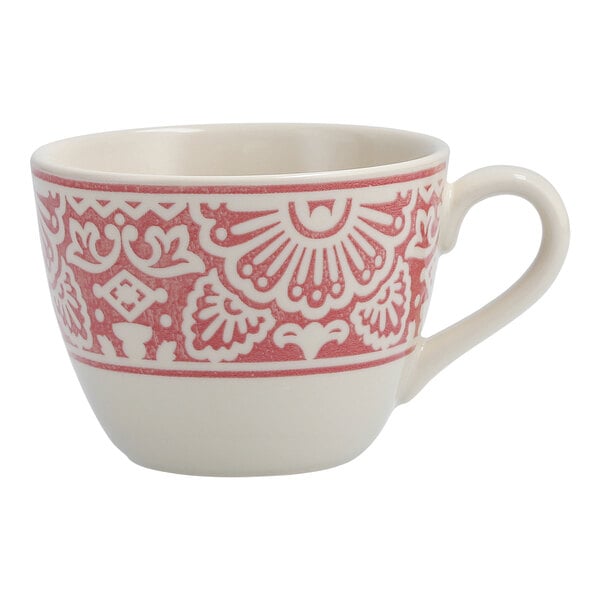 A white coffee cup with a pink and red design.