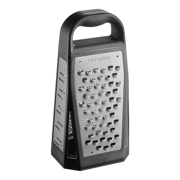 A Microplane stainless steel box grater with black accents.