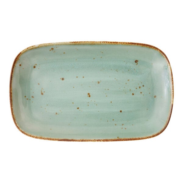 A rectangular Erthe Celadon platter with brown speckles on the edge.