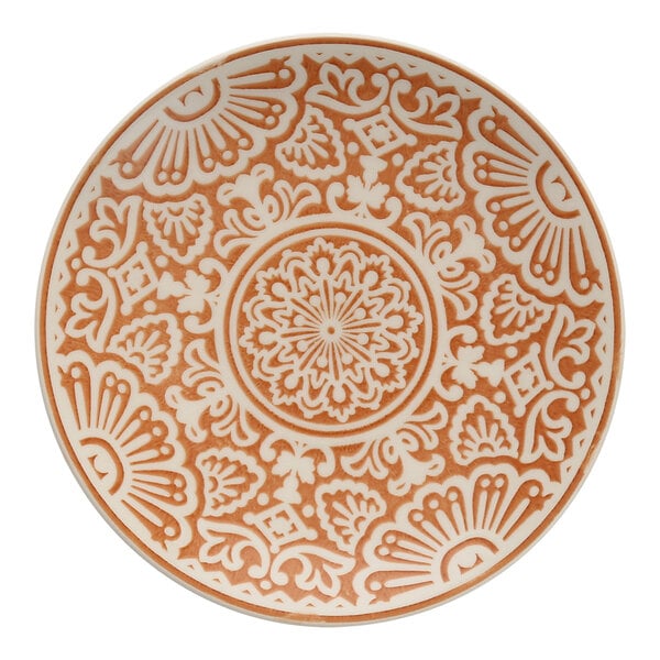 A Havana by Fortessa Adobo coupe plate with an intricate orange and white design.