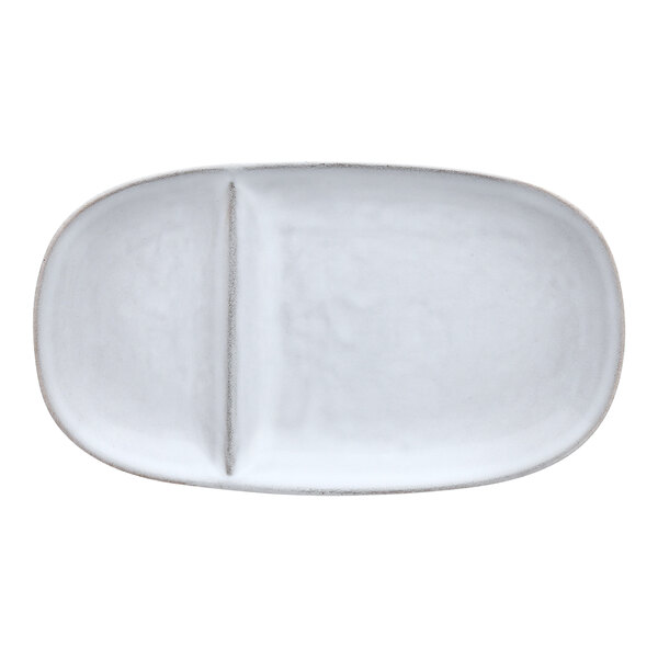 A white oval stoneware platter with two compartments.